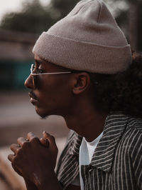 Side view of man looking away wearing beanie 