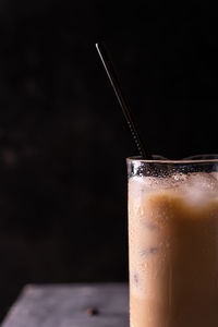 A glass of iced coffee on a table, copy space for text