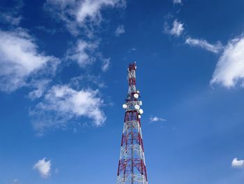 Low angle view of communications tower against sky