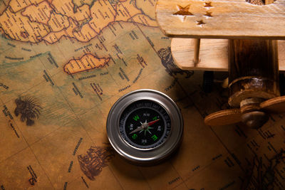 High angle view of compass with toy on table