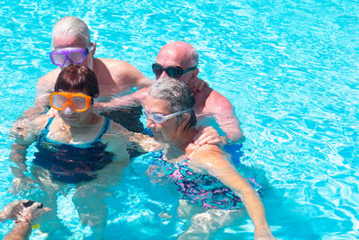 Rear view of man swimming in pool