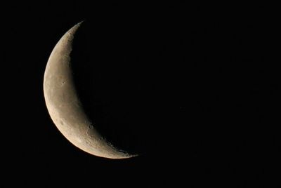 Low angle view of moon in sky at night