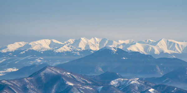 Scenic view of snowcapped mountains against clear sky