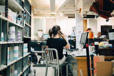 Rear view of woman working in office