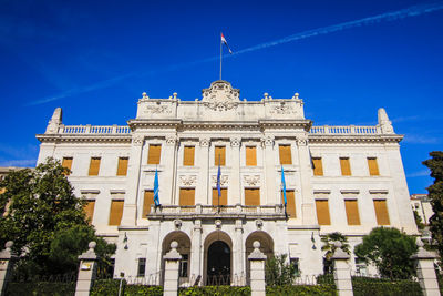 Low angle view of historical building maritime museum - governor palace in rijeka against blue sky