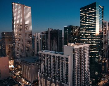 Modern cityscape against clear sky at night