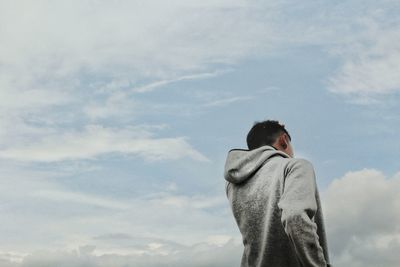 Low angle view of man standing against sky