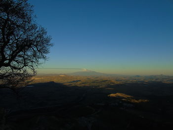 Scenic view of landscape against clear sky at sunset