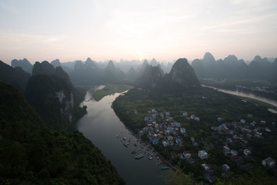 Scenic view of river amidst mountains against sky