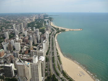 High angle view of sea and buildings against sky