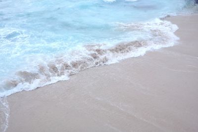 High angle view of waves rushing towards shore