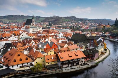 High angle view of townscape by river in city