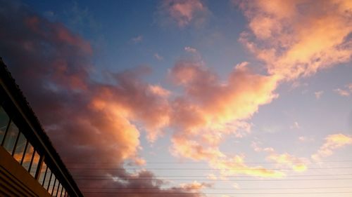 Low angle view of bridge against sky at sunset