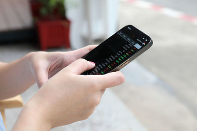 Close-up of hand holding mobile phone