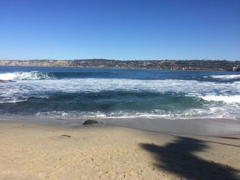 Scenic view of beach against clear sky