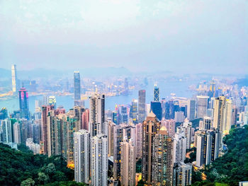 Aerial view of modern buildings in city against sky