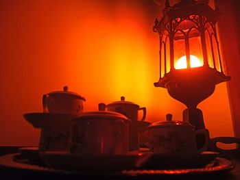 Close-up of illuminated lamp on table