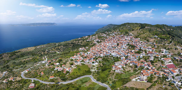 High angle view of townscape by sea against sky