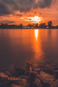 Scenic view of lake against orange sky