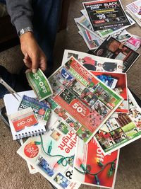 High angle view of hand holding book on table