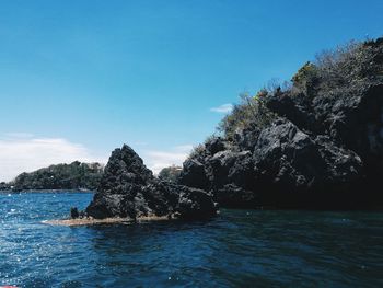 Scenic view of sea against blue sky