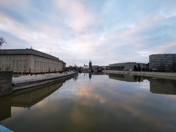 The government building of wroclaw in poland from the view over the oder with pastel-coloured sky 