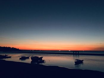 Scenic view of sea against clear sky during sunset