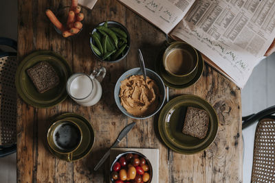 Directly above shot of breakfast arranged on wooden dining table at home