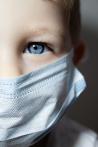 Little boy wears a protective mask