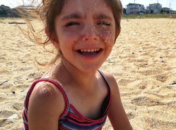 Close-up portrait of smiling boy on beach