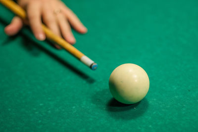 Person playing with ball on table