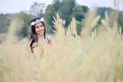 Portrait of smiling young woman on field