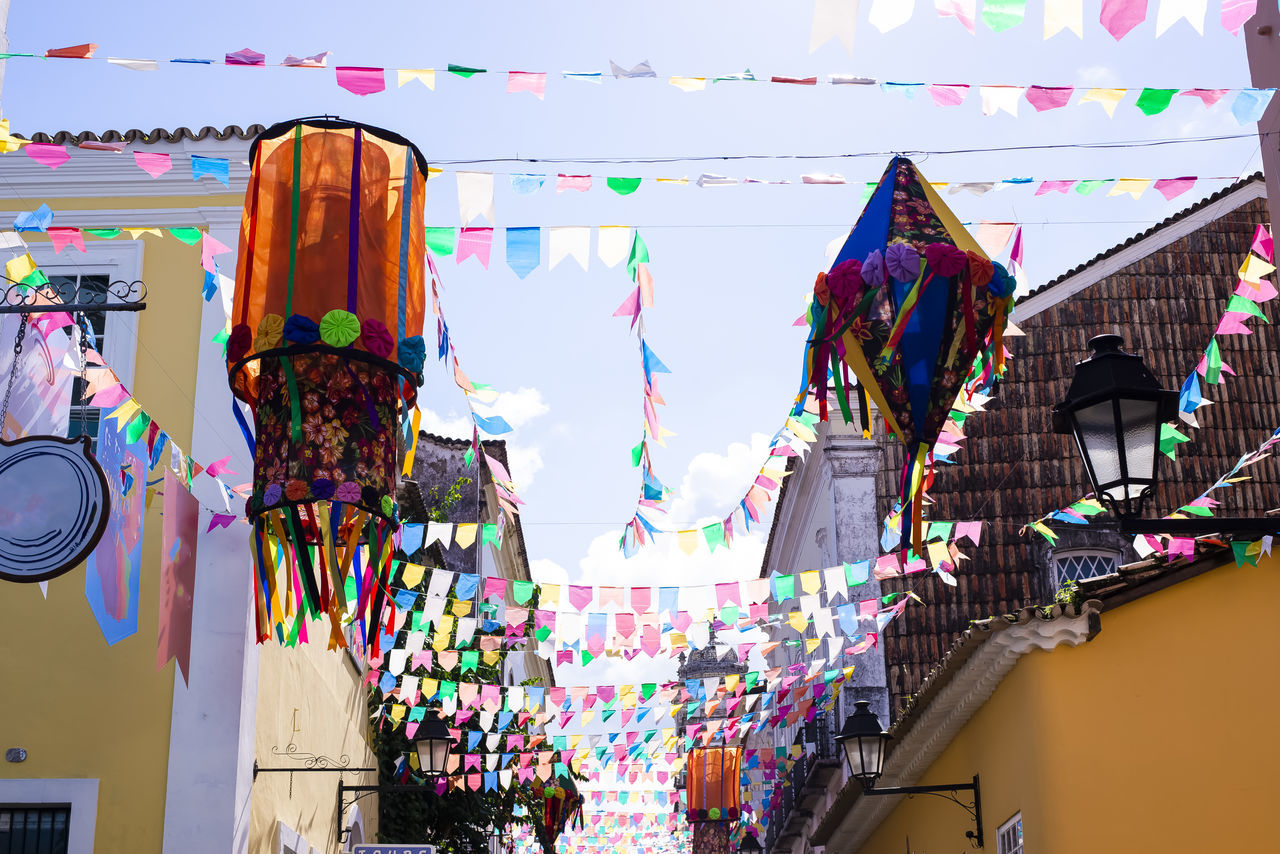 multi colored, hanging, architecture, decoration, celebration, no people, day, city, building exterior, outdoors, sky, built structure