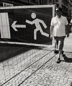 Woman walking on sidewalk