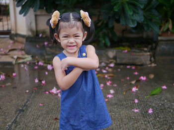 Adorable baby girl, 40 months old, smiling and making cute pose for outdoor photo shoot