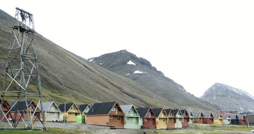 Group of people on mountain against clear sky