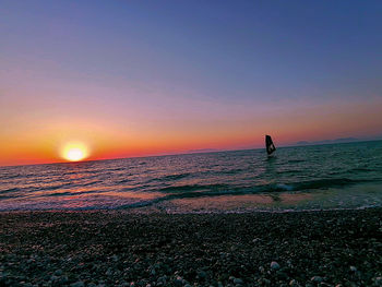 Scenic view of sea against clear sky during sunset