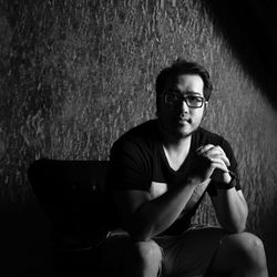 Portrait of young man sitting outdoors