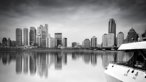 View of skyscrapers against cloudy sky