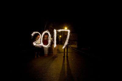 People standing against light painting