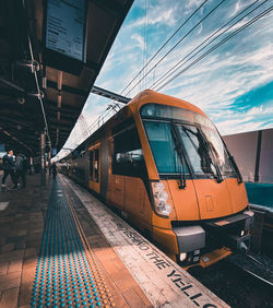 Train at railroad station against sky