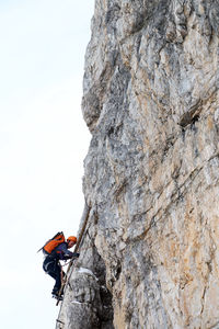 Hiker climbing snow covered mountain