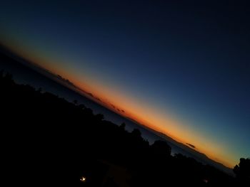 Low angle view of silhouette trees against sky at sunset