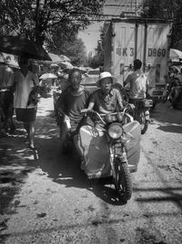 People riding motorcycle on street