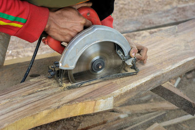 Cropped image of carpenter working on wood