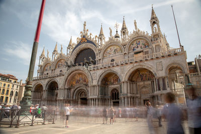 Group of people in front of building against sky