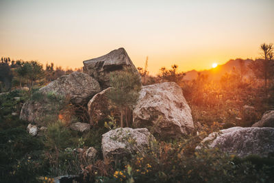 Rock formations against sky during sunset