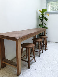 Empty chairs and table against wall at home