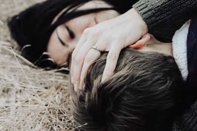 High angle view of son with mother while lying on grass