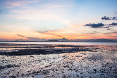 Scenic view of beach against sky during sunset